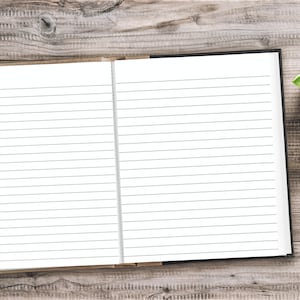 May include: An open lined notebook with a black cover on a wooden surface. A green succulent plant is in the upper right corner of the image.
