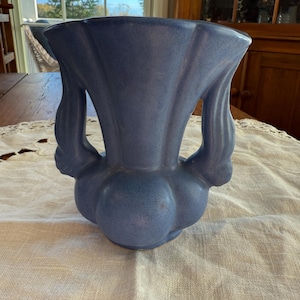 May include: A rustic wooden sign with the text "Welcome to our home" in white lettering. The sign features a distressed finish and a simple, inviting design, perfect for entryway decor.