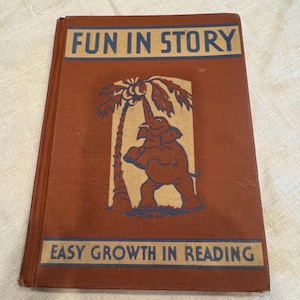 Puede incluir: Un libro marrón con el título "Fun in Story" y el subtítulo "Easy Growth in Reading". La portada presenta una ilustración de un elefante que alcanza un coco en una palmera.