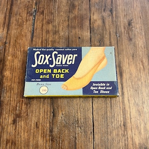 May include: A blue and yellow package for Sox-Saver open back and toe shoe protectors. The package shows a woman's foot wearing the product. The package says "Made of fine quality combed cotton yarn" and "Invisible in Open Back and Toe Shoes". The package also says "Hose Size 10".