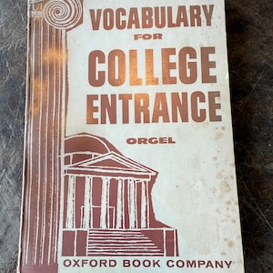 May include: Vintage "Vocabulary for College Entrance" book by Orgel from Oxford Book Company. The cover features a brown illustration of a classical building and a column with a spiral design. The title and author's name are in brown lettering.