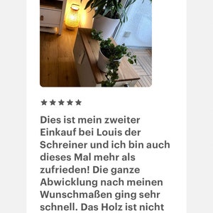 May include: A five-star review of a wooden table with a natural wood finish. The table is decorated with two potted plants and a lamp. The review text reads: "This is my second purchase from Louis the carpenter, and I am even more satisfied this time! The entire process, according to my specifications, was very fast. The wood is beautiful and easy to work with."