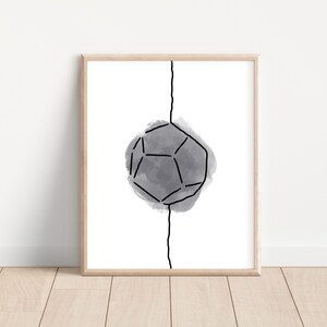 May include: Framed art print featuring a geometric shape with black lines and a gray watercolor background. A vertical black line bisects the artwork. The print is displayed in a light-colored wooden frame, suitable for modern home decor.