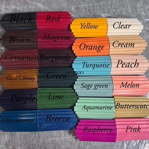 May include: A collection of rectangular wax sticks arranged in a grid, each labeled with color names including Black, Red, Yellow, Clear, Brown, Magenta, Orange, Cream, Cinnamon, Burgundy, Turquoise, Peach, Golden honey, Green, Sage green, Melon, Purple, Lime, Aquamarine, Butterscotch, Ultramarine, Breeze, Raspberry, and Pink.