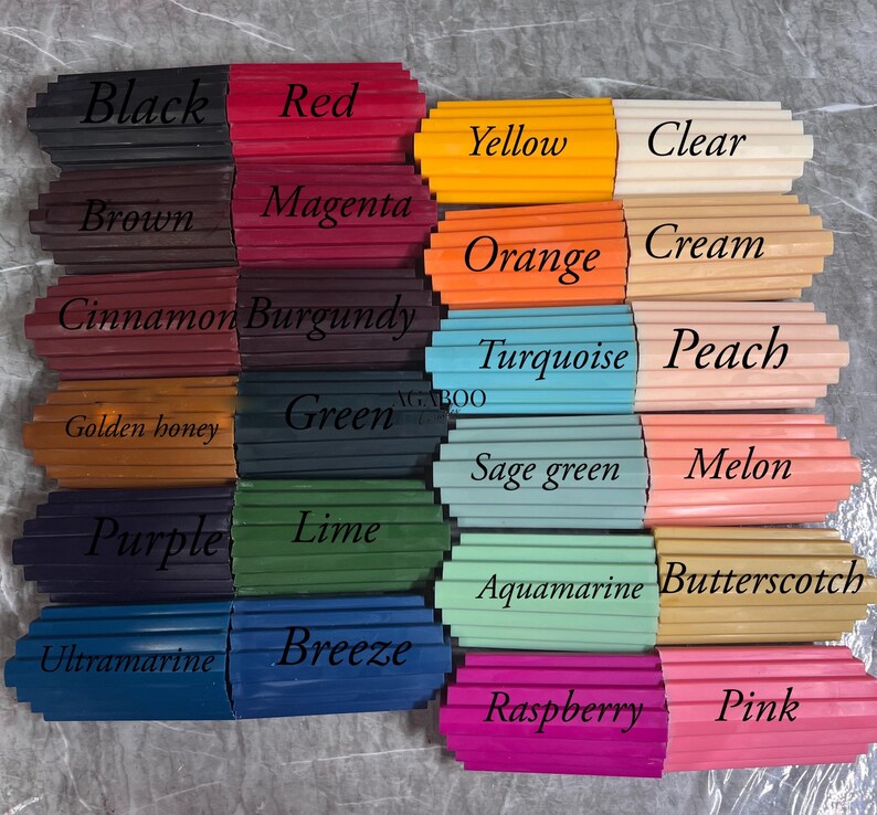 May include: A collection of rectangular wax sticks arranged in a grid, each labeled with color names including Black, Red, Yellow, Clear, Brown, Magenta, Orange, Cream, Cinnamon, Burgundy, Turquoise, Peach, Golden honey, Green, Sage green, Melon, Purple, Lime, Aquamarine, Butterscotch, Ultramarine, Breeze, Raspberry, and Pink.