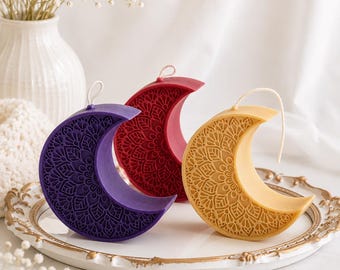 May include: Three crescent moon-shaped candles in purple, deep red, and golden yellow. Each candle features an intricate, embossed mandala-style pattern on its front surface and includes a single white wick at the top for lighting.