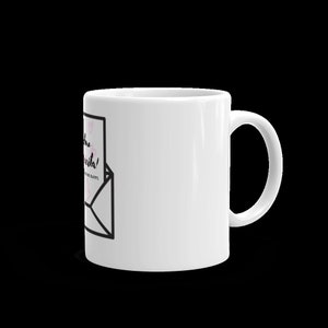 May include: White ceramic mug with a black and white illustration of an envelope with a pink heart pattern and the text "Love the little things!" inside. The text "MAKE ME HAPPY." is below the envelope.