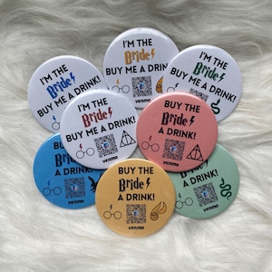 May include: A set of seven round buttons with a Harry Potter theme. The buttons are pink, blue, green, and yellow. Each button has a different design with the text "I'm the Bride" or "Buy the Bride a Drink!" and a QR code. The buttons also feature Harry Potter symbols like lightning bolts, glasses, and the Deathly Hallows symbol.