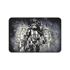 May include: A black and white illustration of three stormtroopers from Star Wars. The stormtroopers are standing in a line, with the middle stormtrooper in the centre of the image. The background is a dark grey with a textured, abstract design.