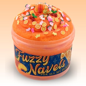 May include: A clear plastic container filled with orange textured slime, topped with miniature charms including orange slices, cherries, a small glass, and crowns. The label on the front features the text "Fuzzy Navels FOR ALL MY FRIENDS".