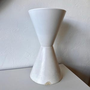 May include: A set of three ceramic mugs with a speckled, matte finish. The mugs are in shades of cream, light gray, and dark gray. Each mug has a simple, minimalist design, perfect for coffee or tea.