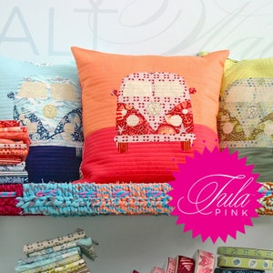 May include: Three colorful pillow covers with a vintage van design. The pillows are on a colorful, woven shelf with the text "Tula Pink" in pink.