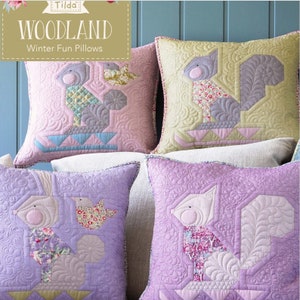 May include: Four decorative throw pillows with a woodland theme. The pillows are made of quilted fabric and feature a variety of animal designs, including squirrels, birds, and rabbits. The pillows are in shades of pink, purple, and green.