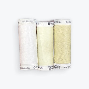 May include: Three spools of thread, one white, one pale yellow, and one beige. The spools are labeled "All Purpose" and "Sew-ology".