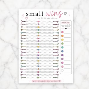 May include: A white habit tracker sheet titled small wins with the subtitle every little win adds up. It features twenty horizontal rows of circles with central icons like hearts, stars, and smiley faces, plus a colour key box on the right.