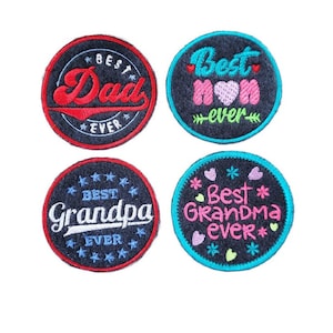 May include: Four round embroidered patches with black felt backgrounds and colorful embroidery. The patches read "Best Dad Ever", "Best Mom Ever", "Best Grandpa Ever", and "Best Grandma Ever".
