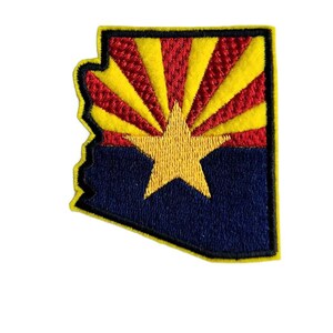 May include: An embroidered patch in the shape of the state of Arizona with the state flag design. The flag features a red sun with yellow rays and a yellow star on a blue background. The patch is outlined in yellow.