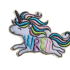 May include: White unicorn with a rainbow mane and tail. The unicorn is running and the word "WREN" is embroidered on its side in rainbow colors.