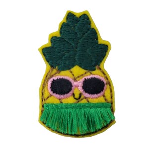 May include: A yellow felt pineapple with a green felt top, pink sunglasses, and a green felt hula skirt.