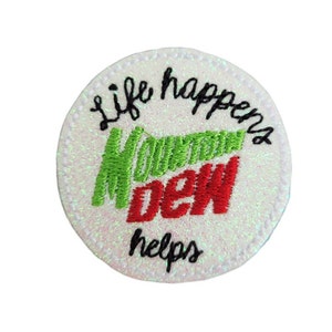 May include: White round embroidered patch with the words "Life happens Mountain Dew helps" and the Mountain Dew logo in green and red.