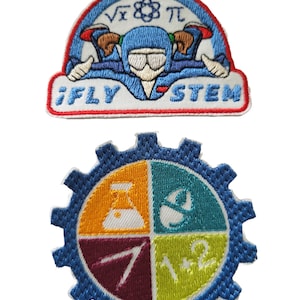 May include: Two embroidered patches. The first patch is blue, red, and white with a cartoon of a girl skydiving. The text "iFLY STEM" is below the girl. The second patch is blue with a white gear shape. Inside the gear are four colored sections with symbols representing science, technology, engineering, and math.