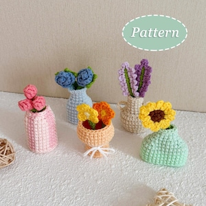 May include: A collection of handmade crochet flower arrangements in miniature vases. The vases are in various colors, including pink, blue, orange, and green, each holding a different type of crocheted flower. The word "Pattern" is in a light green oval.