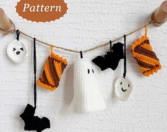 May include: A handmade Halloween garland featuring crocheted decorations. The garland includes a white ghost, black bats, and orange and brown striped candies. Additional decorations include a white circle with a face and a white circle with a smiling face. The word "Pattern" is in an oval.