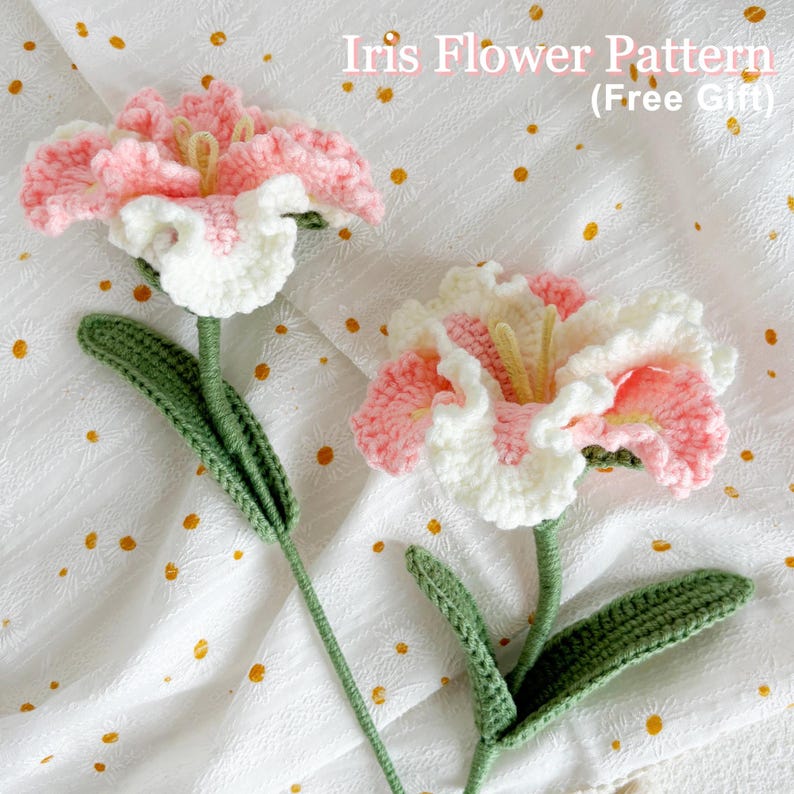 May include: Two crocheted pink and white iris flowers with green stems and leaves on a white background with gold polka dots.  "Iris Flower Pattern (Free Gift)" is written in black text at the top of the image.
