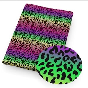 May include: Rainbow leopard print fabric with a close-up of the pattern. The fabric is a gradient of pink, purple, green, and yellow.