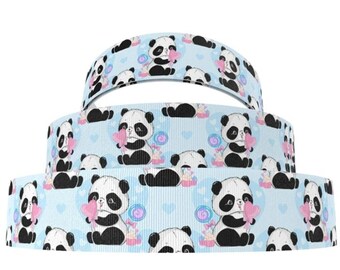 May include: Blue ribbon with a repeating pattern of black and white pandas holding pink hearts and candy. The pandas are on a light blue background with white hearts and pink candy.