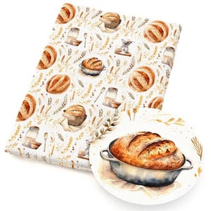 May include: A rectangular fabric piece featuring a repeating watercolor pattern of golden-brown sourdough loaves in metal pots, glass jars, and wheat stalks. A circular inset shows a detailed view of a single loaf in a metal baking dish.
