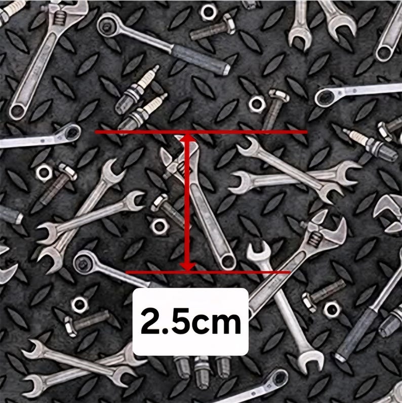 May include: A pattern of various silver-colored metal tools including wrenches, spark plugs, bolts, and nuts arranged on a dark gray diamond plate background. A red measurement line indicates a specific wrench length of 2.5 cm.