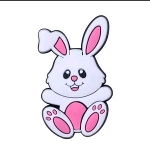 Peut inclure: Un lapin blanc avec des oreilles roses, un ventre rose et des empreintes de pattes roses sur ses pieds. Le lapin est assis les jambes croisées et a une expression joyeuse sur son visage.