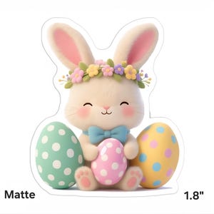 May include: A matte Easter bunny sticker with a floral crown and a blue bow tie. The bunny is holding a pink polka-dot egg, with a green and yellow polka-dot egg on either side. The sticker is 4.57 cm in height.