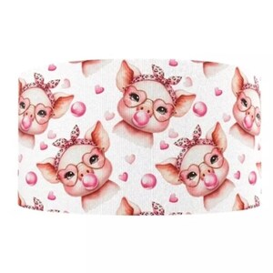 May include: White fabric with a repeating pattern of pink pigs wearing pink glasses and pink bows. Each pig is blowing a pink bubble. There are also pink hearts scattered throughout the pattern.