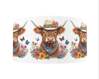 May include: A repeating pattern featuring three Highland cows. Each cow wears a straw hat adorned with flowers, a patterned bandana, and is surrounded by colorful flowers and butterflies. The cows have long, shaggy brown fur.