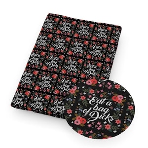 May include: Black fabric with a floral pattern and the text "Eat a bag of Dicks" in white. The design includes red and pink flowers, green leaves, and small white stars.