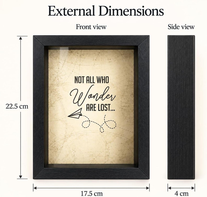 May include: A black shadow box frame with a beige background featuring a map pattern and the text "NOT ALL WHO Wonder ARE LOST..." with a paper airplane graphic. The frame measures 22.5 cm in height, 17.5 cm in width, and 4 cm in depth.