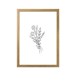 May include: A framed black and white line drawing of a bouquet of wildflowers. The drawing is simple and elegant, with delicate lines and a minimalist aesthetic.