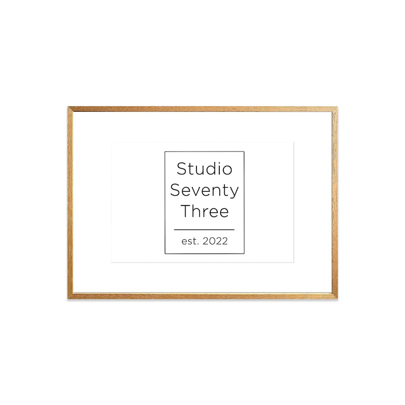 May include: A gold-colored frame with a white mat and a black and white logo that reads "Studio Seventy Three est. 2022".