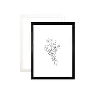 May include: A black framed print featuring a simple line drawing of a bouquet of flowers in shades of grey.