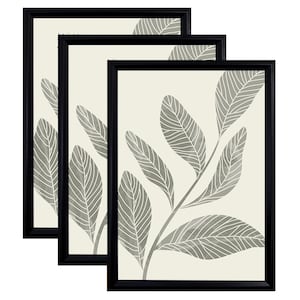 May include: Set of three framed prints featuring a stylised illustration of a branch with leaves in shades of grey on a cream background. The frames are black.