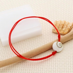 Bracelet adulte œil Ste Lucie sur cordon rouge