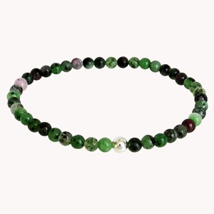 May include: A green and pink gemstone bracelet with a silver bead accent. The bracelet is made of small, round beads.