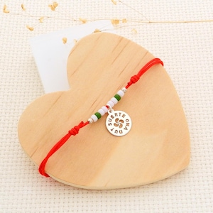 Red cord bracelet with silver medal in the Basque cross "suerte ona dut"