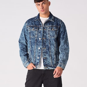 May include: A blue denim jacket with a faded, distressed look. The jacket has a button-up front, long sleeves, and two chest pockets.