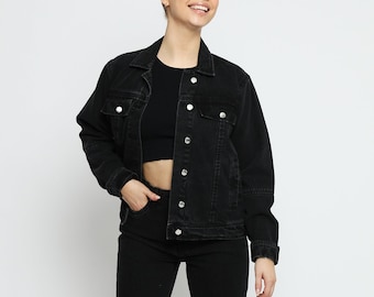 May include: A black denim jacket with a button closure and two front pockets. The jacket has a relaxed fit and is made of a soft, comfortable fabric.