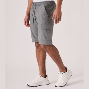 May include: A pair of gray cargo shorts with a drawstring waist and multiple pockets. The shorts are made of a lightweight fabric and are perfect for casual wear.