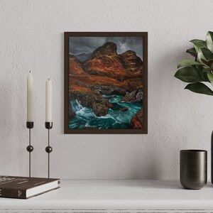 May include: Framed landscape painting of a river flowing through a rocky canyon with a cloudy sky in the background.