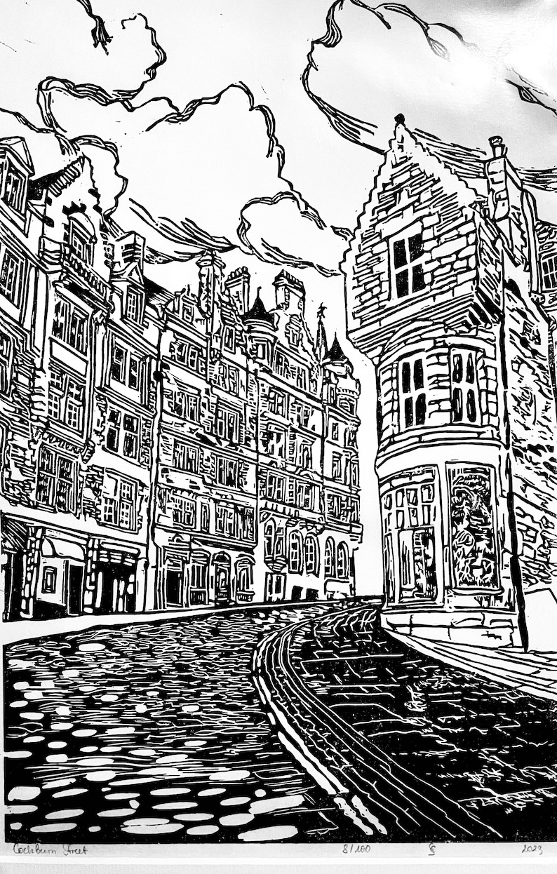 May include: Black and white woodcut print of a cobblestone street in Edinburgh, Scotland. The print features a row of buildings with tall windows and a corner building with a rounded bay window. The street is empty and the sky is cloudy.